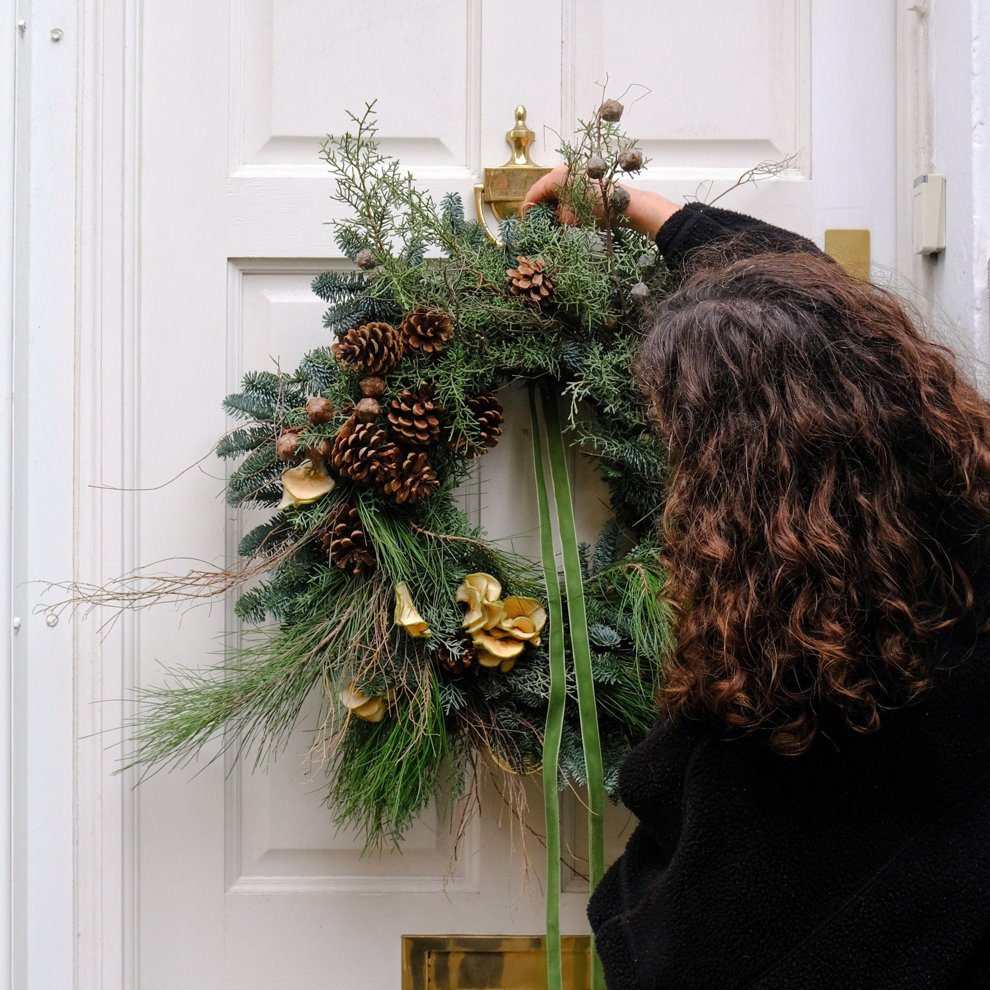 festive Christmas wreath with pine cones and dried apple slices