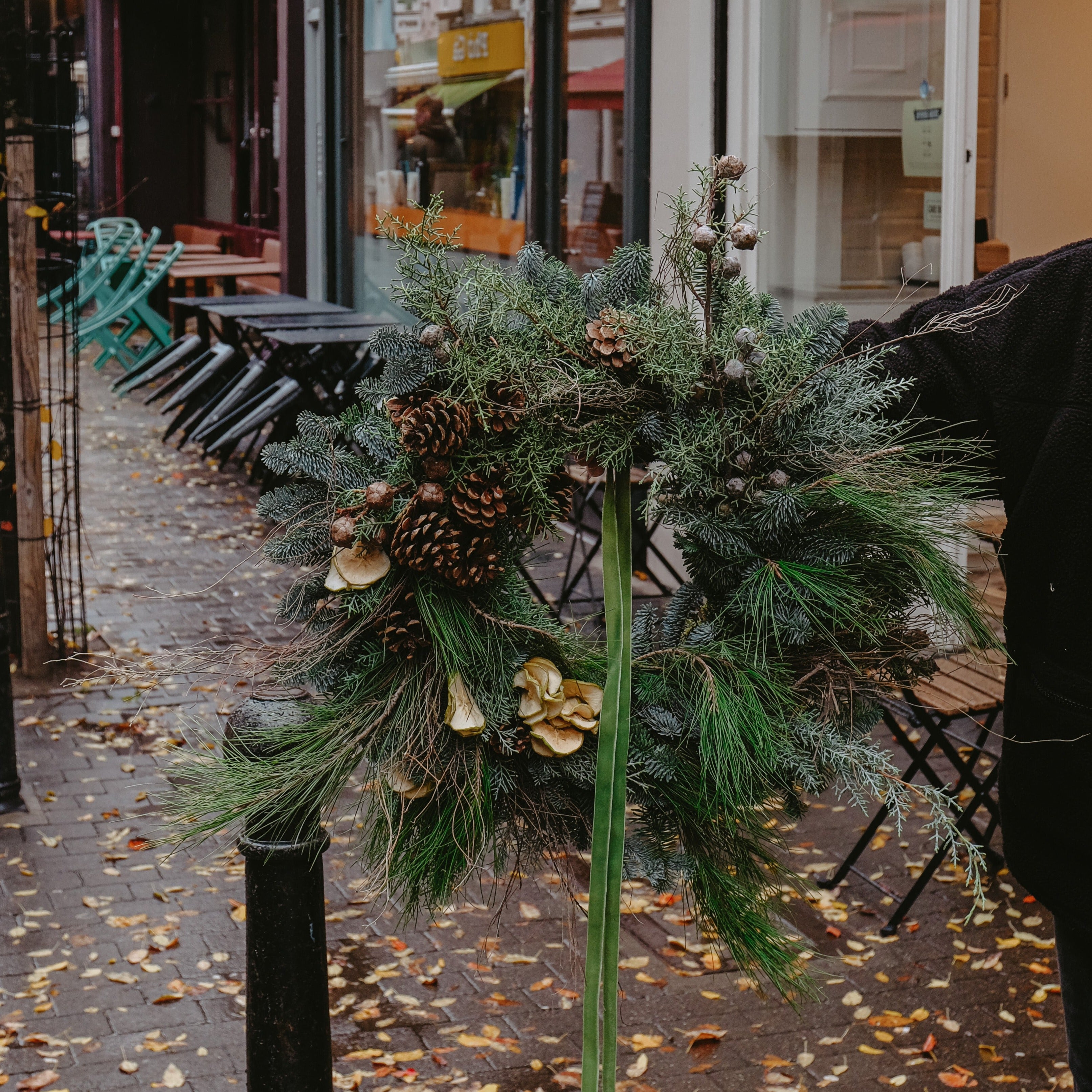 festive Christmas wreath to buy online for delivery in London and UK. Made with pine cones and festive foliage