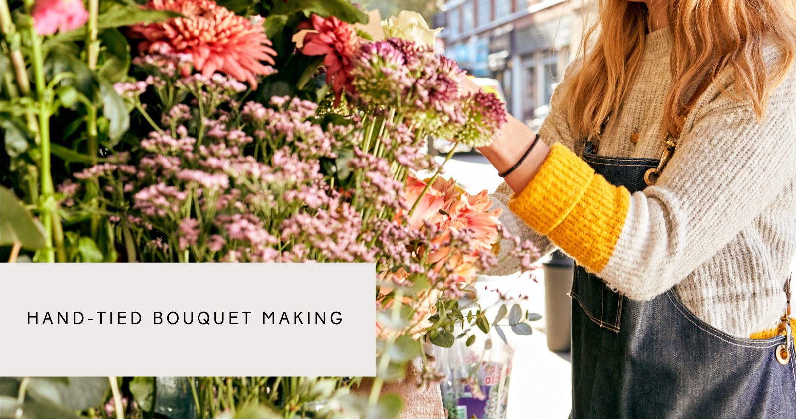 a lady preparing flowers for a hand-tied bouquet workshop in london