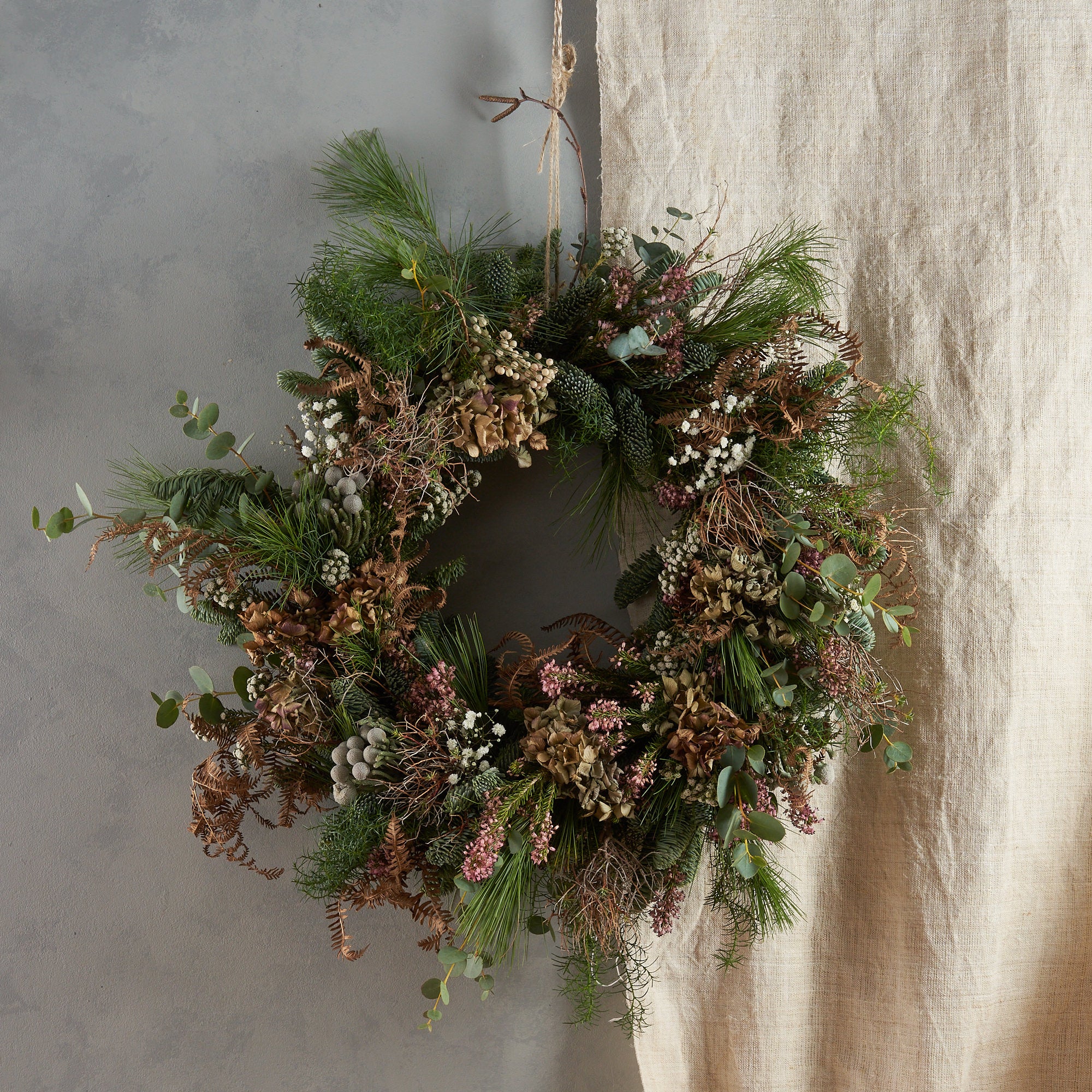 modern and contemporary christmas wreath with dried flowers and grasses