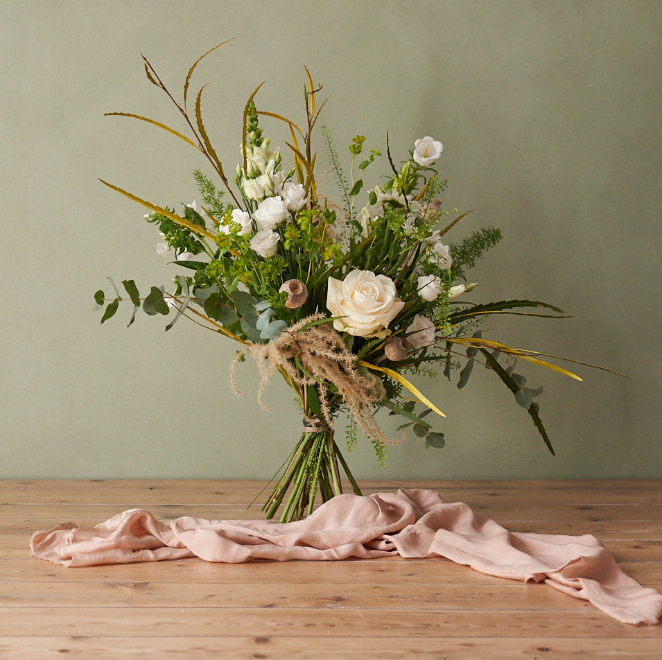 whimsical white bouquet with white roses, eucalyptus, grasses