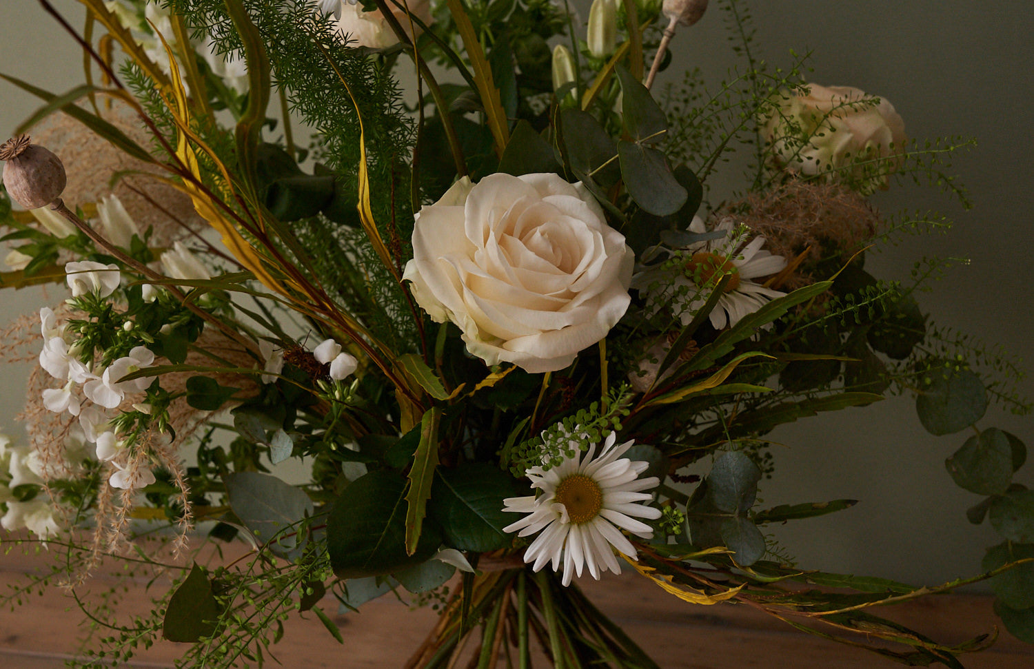 whimsical white bouquet with white roses, eucalyptus, grasses