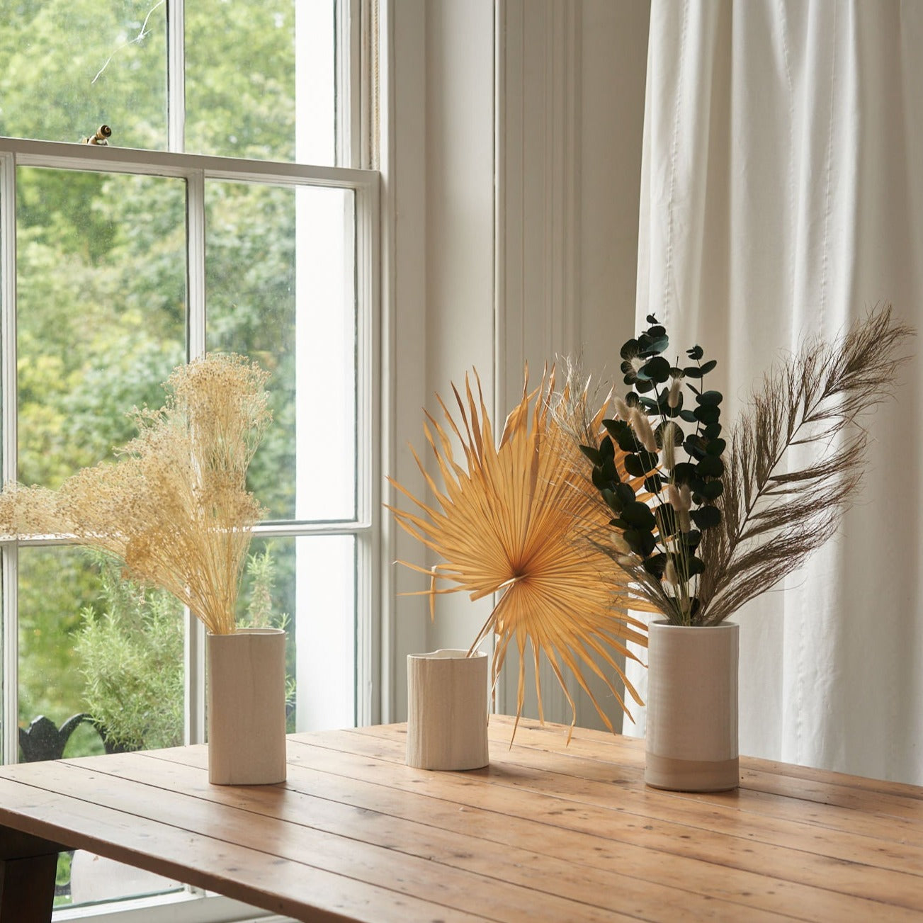 dried flower bunches in stoneware vases interior