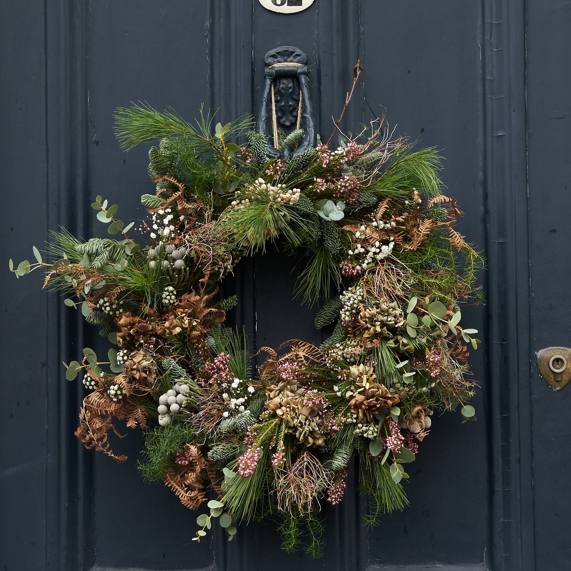 modern and contemporary christmas wreath with dried flowers and grasses