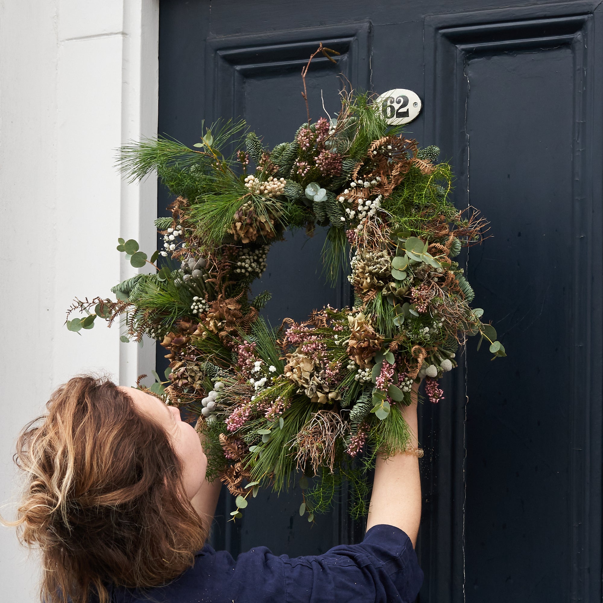 modern and contemporary christmas wreath with dried flowers and grasses