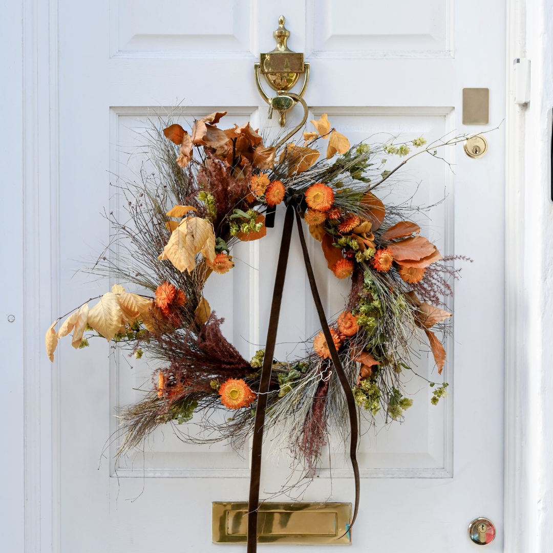 dried autumn wreath in orange tones with straw flower
