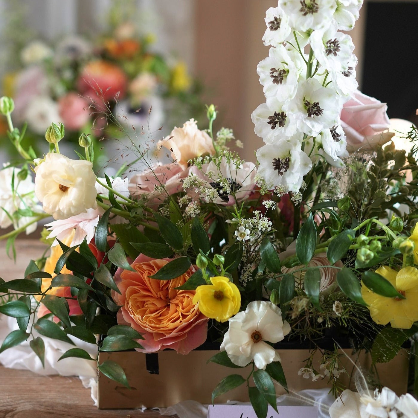 midsummer bloom trough arrangement with vibrant and fresh flowers for weddings and events