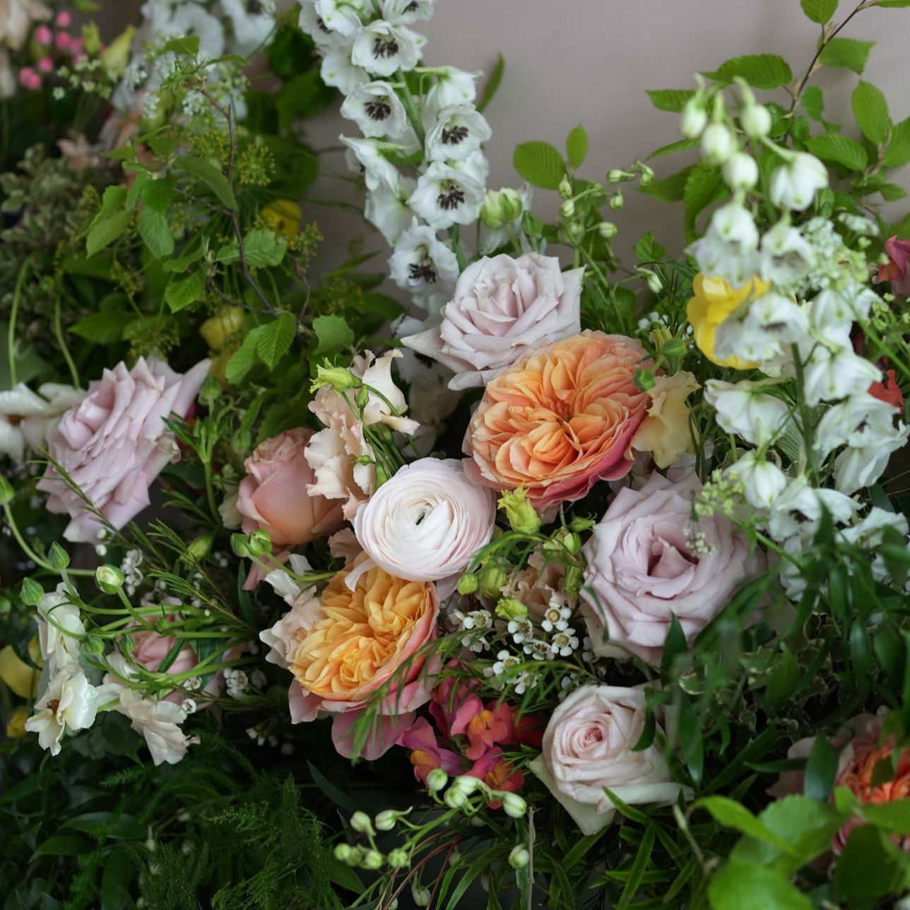 colourful and vibrant trough arrangement to dress up wedding venues and mantlepieces