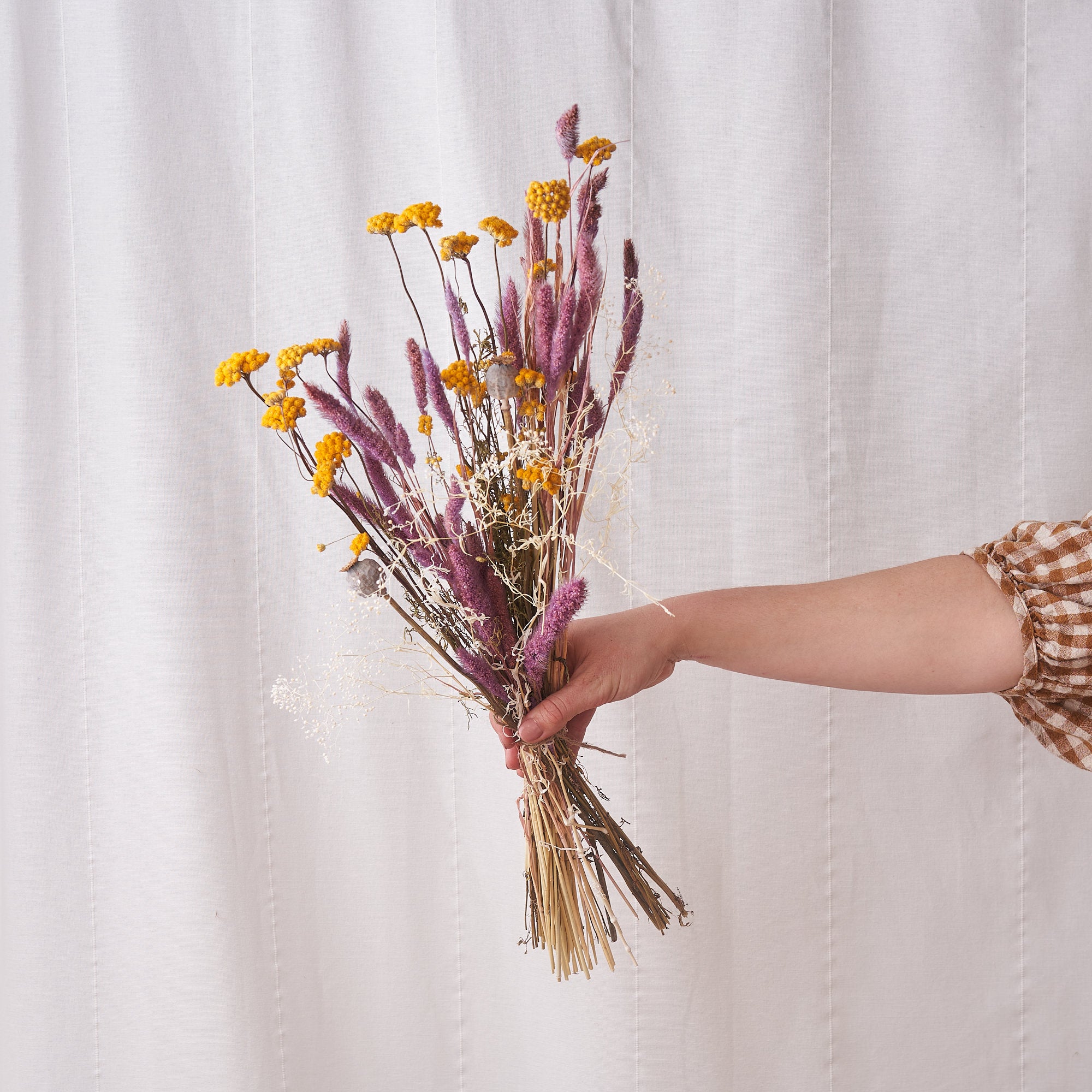 preserved bunch of dried flowers with yellow and pink