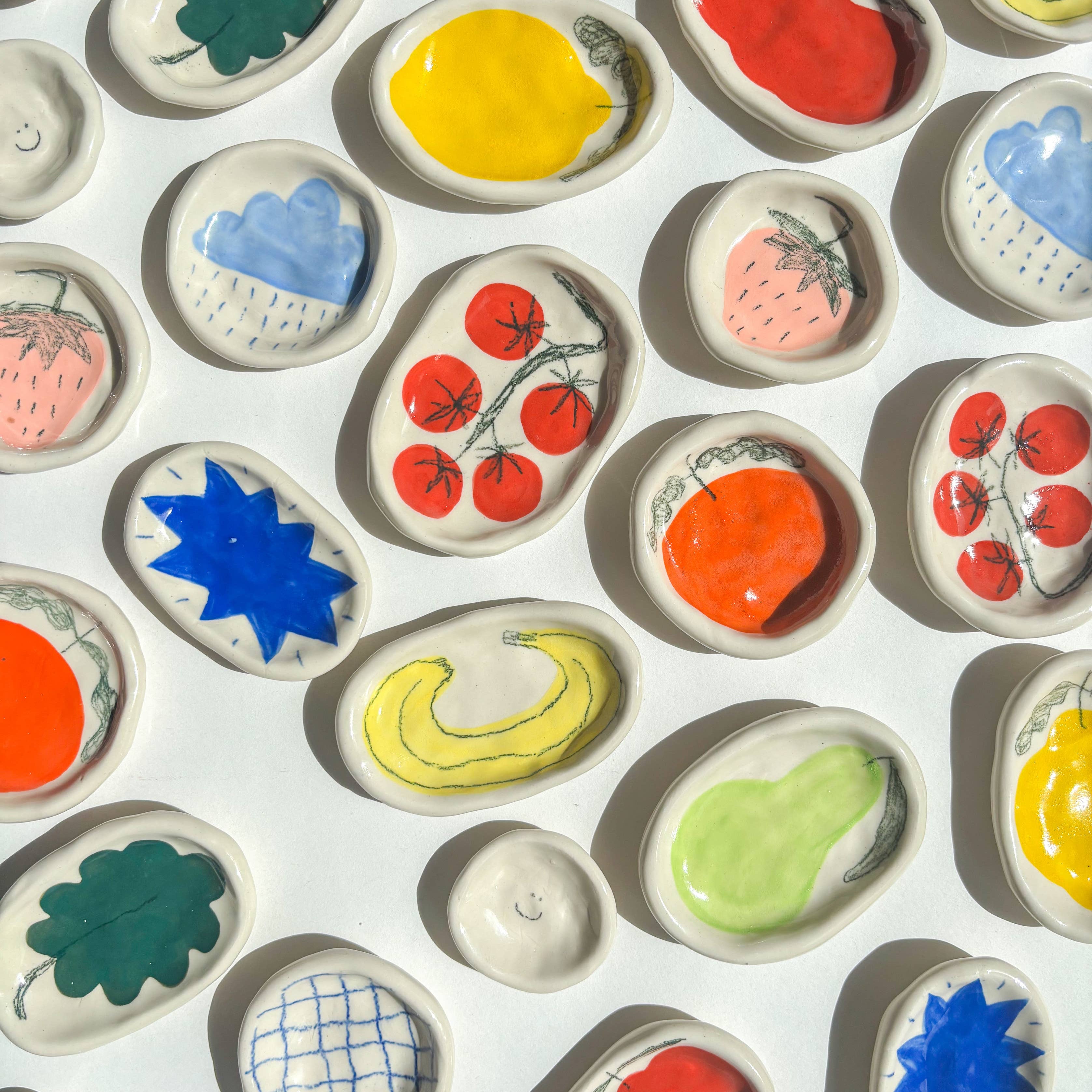 Colorful ceramic tiles with various designs on a white background