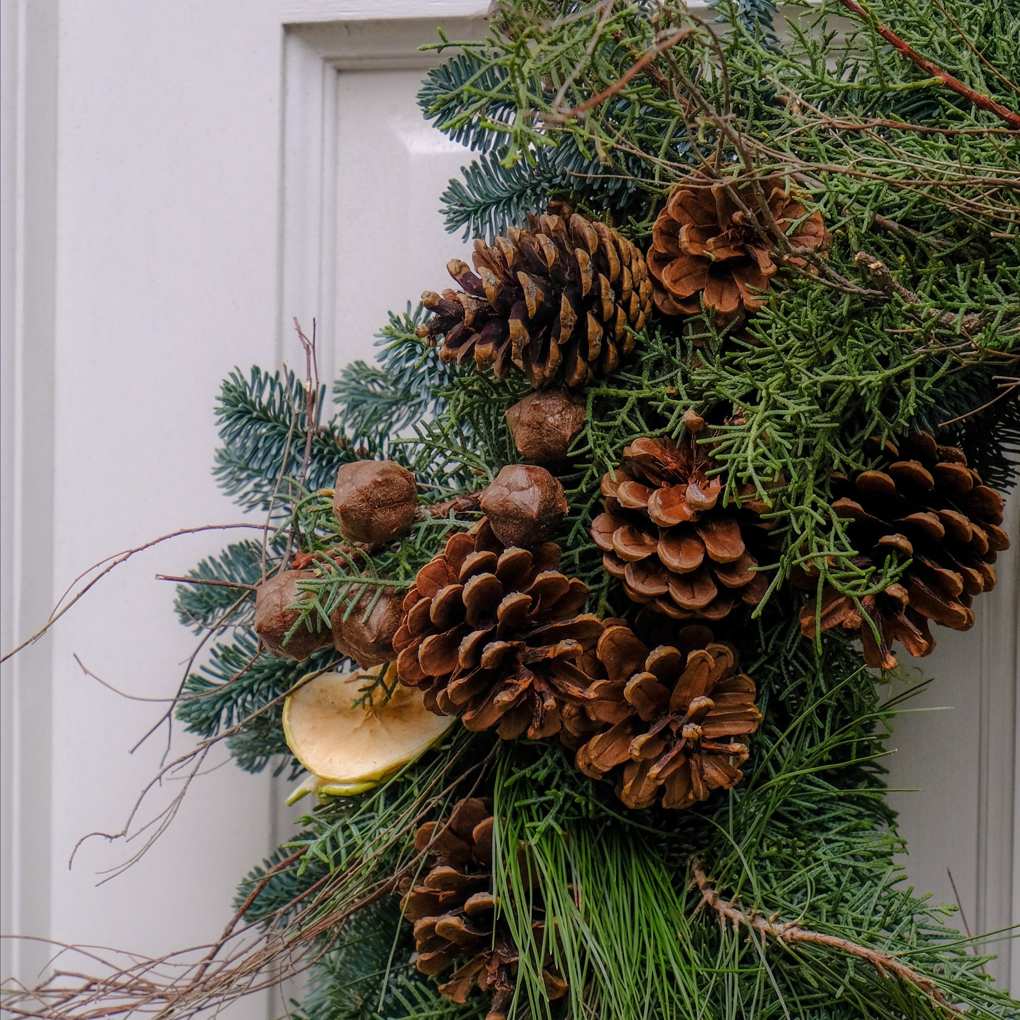 festive Christmas wreath with pine cones and dried apple slices