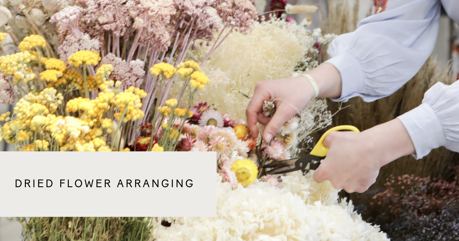 someone making a dried flower arrangement at a Botanique flower workshop in london