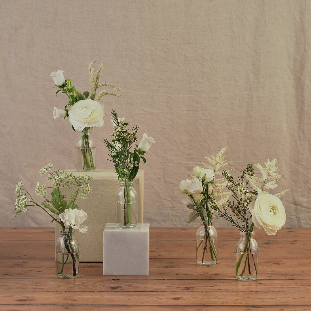white and green wedding table decorations with seasonal flowers and green foliage