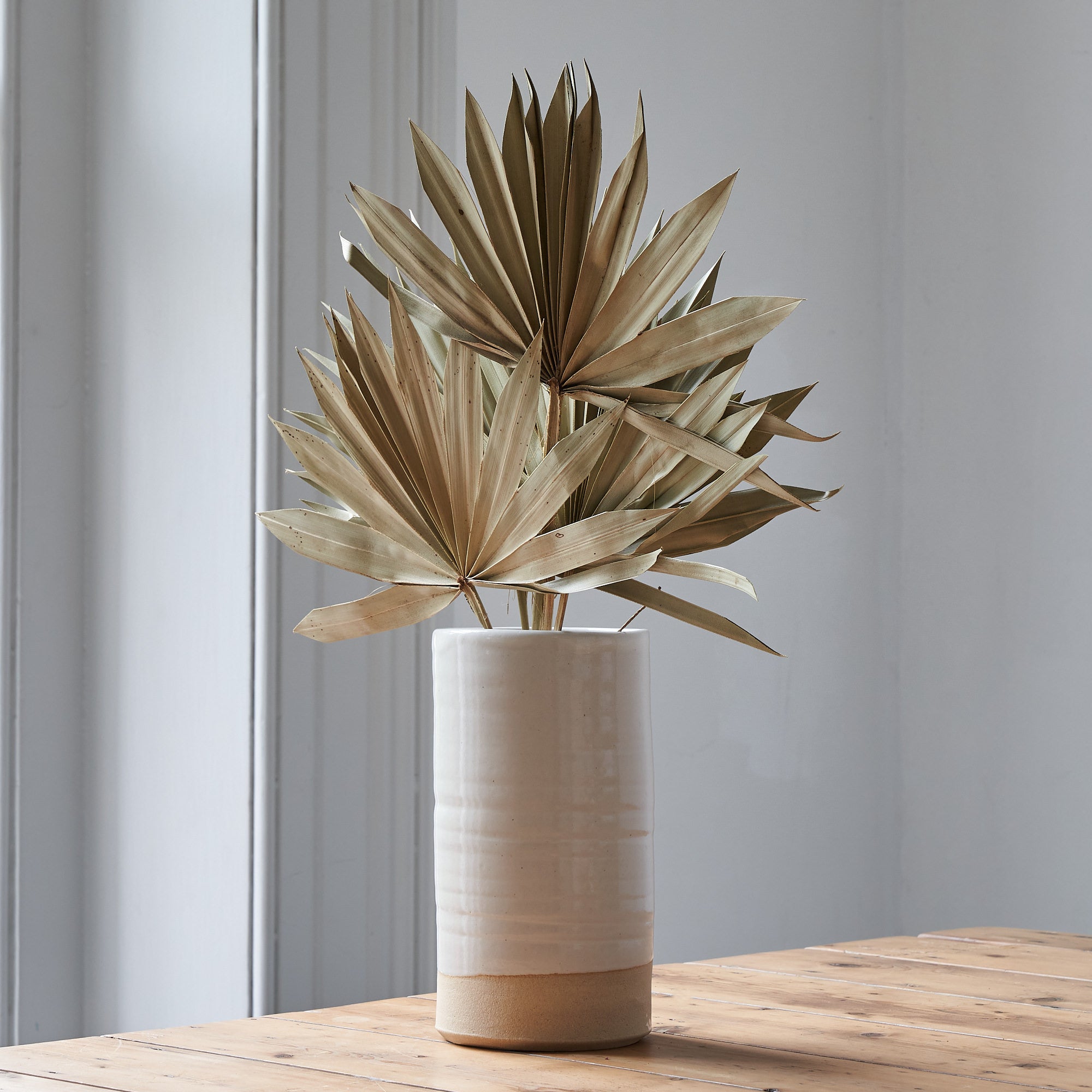 dried palm leaves in ceramic vase