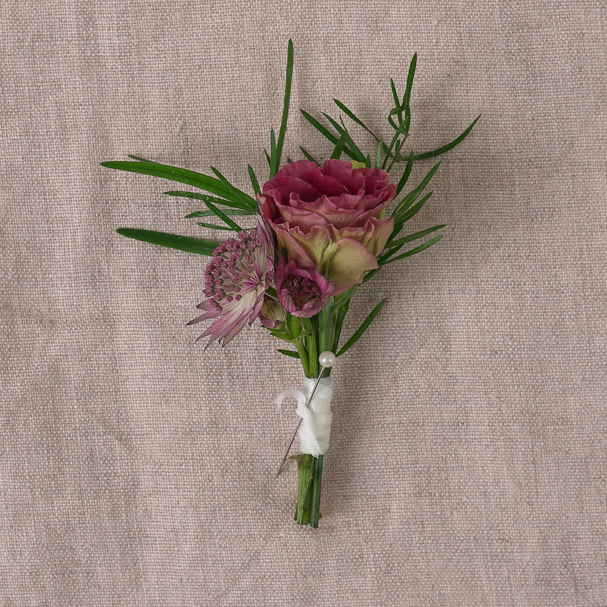buttonhole or corsage in burgundy autumnal colour palette