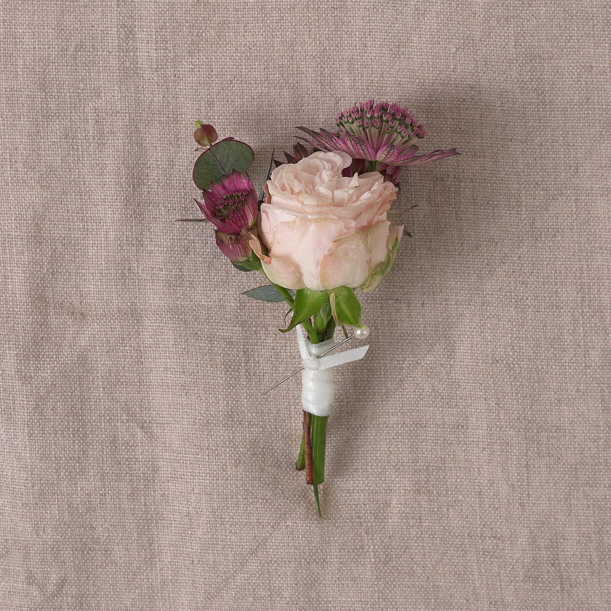 buttonhole or corsage in burgundy autumnal colour palette