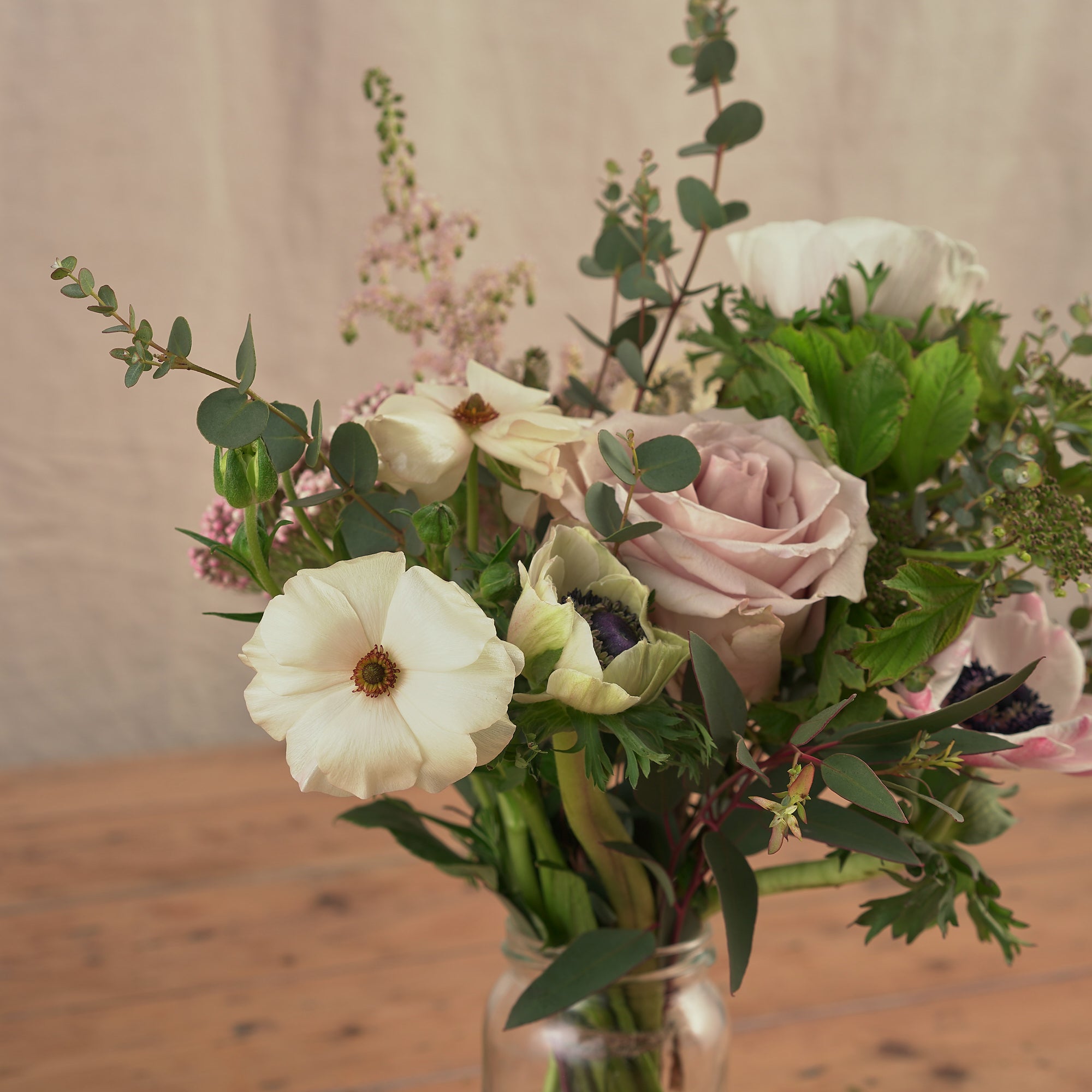 english country garden style flowers in jam jars for weddings and events
