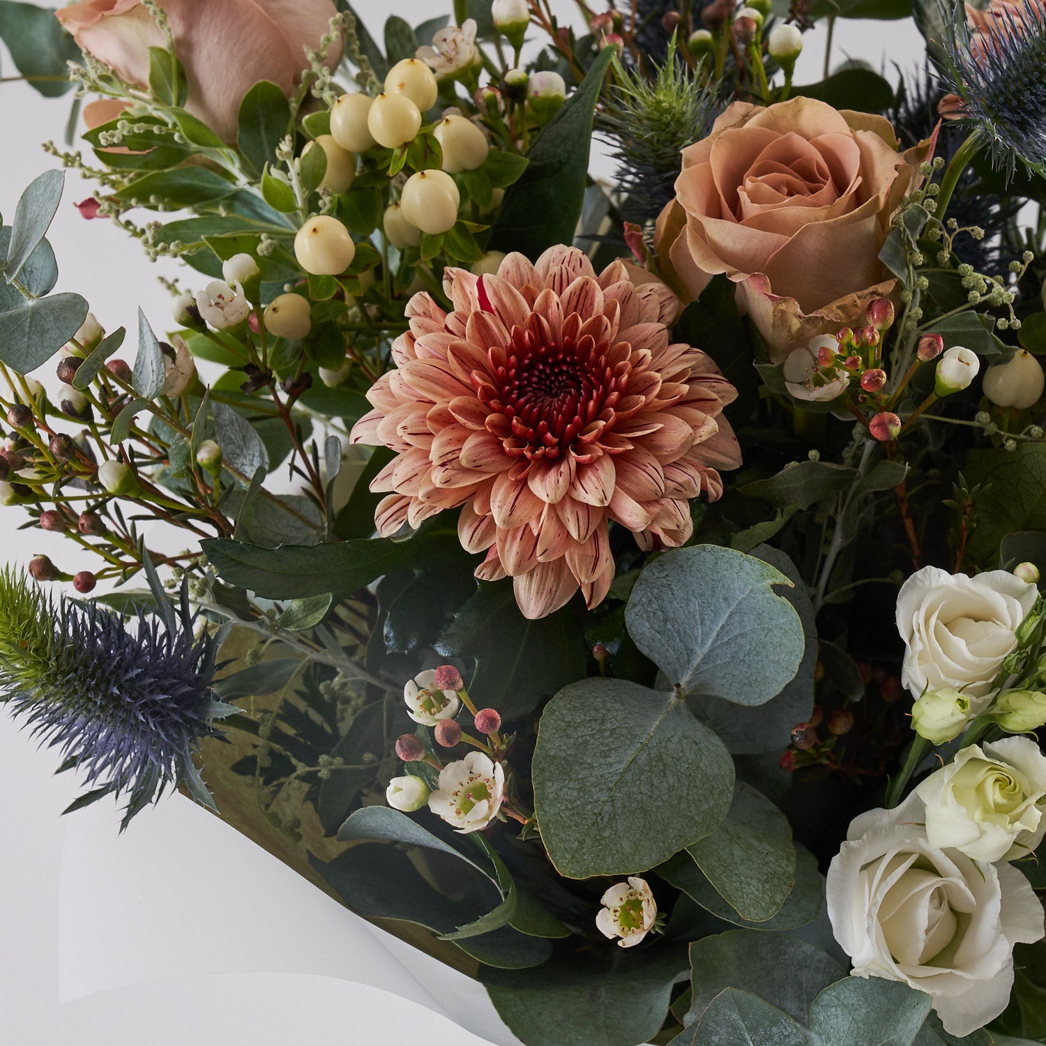 muted tones fresh flower bouquet with eucalyptus roses and thistle