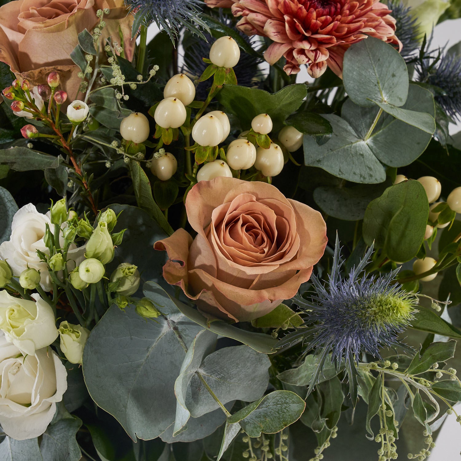 muted tones fresh flower bouquet with eucalyptus roses and thistle