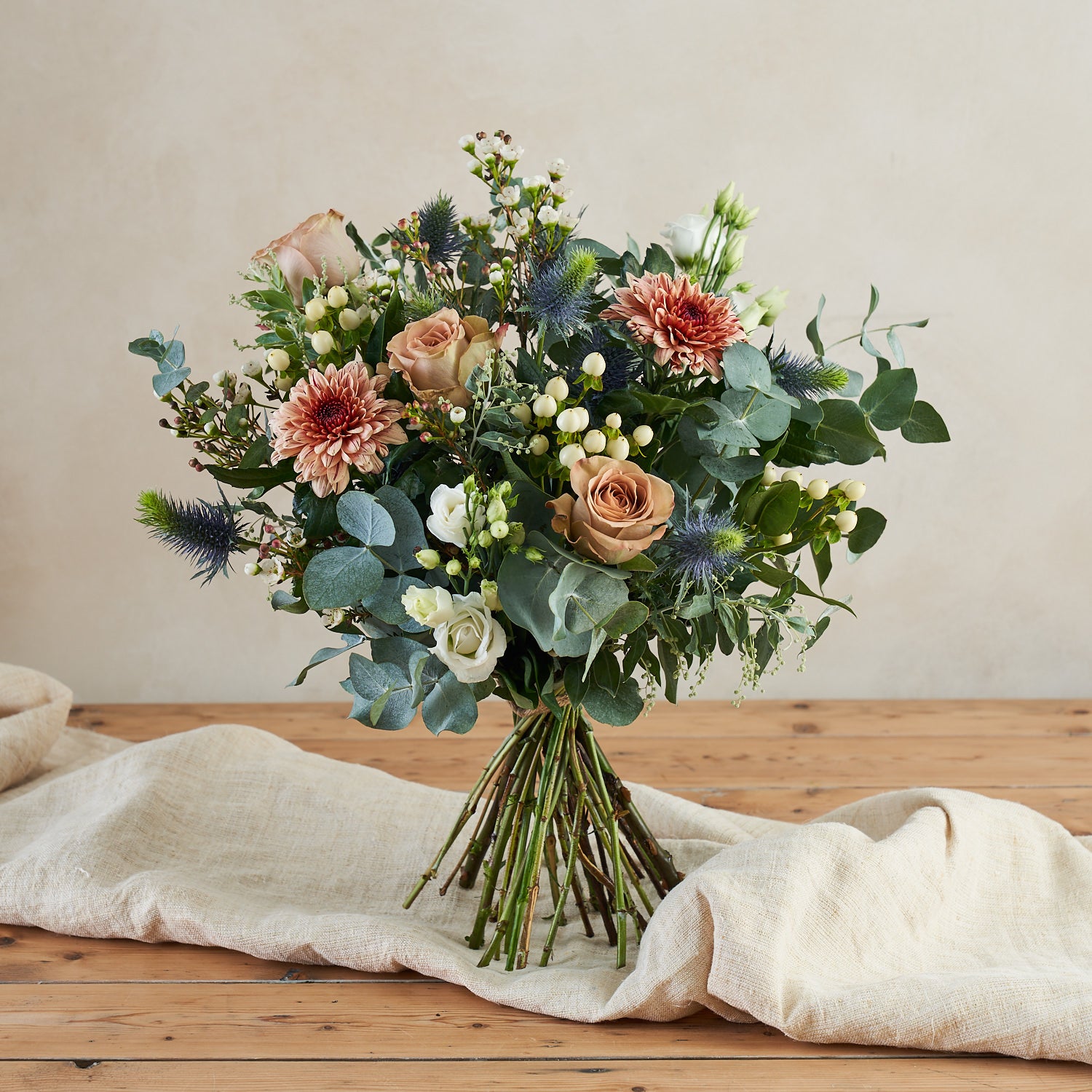 muted tones fresh flower bouquet with eucalyptus roses and thistle