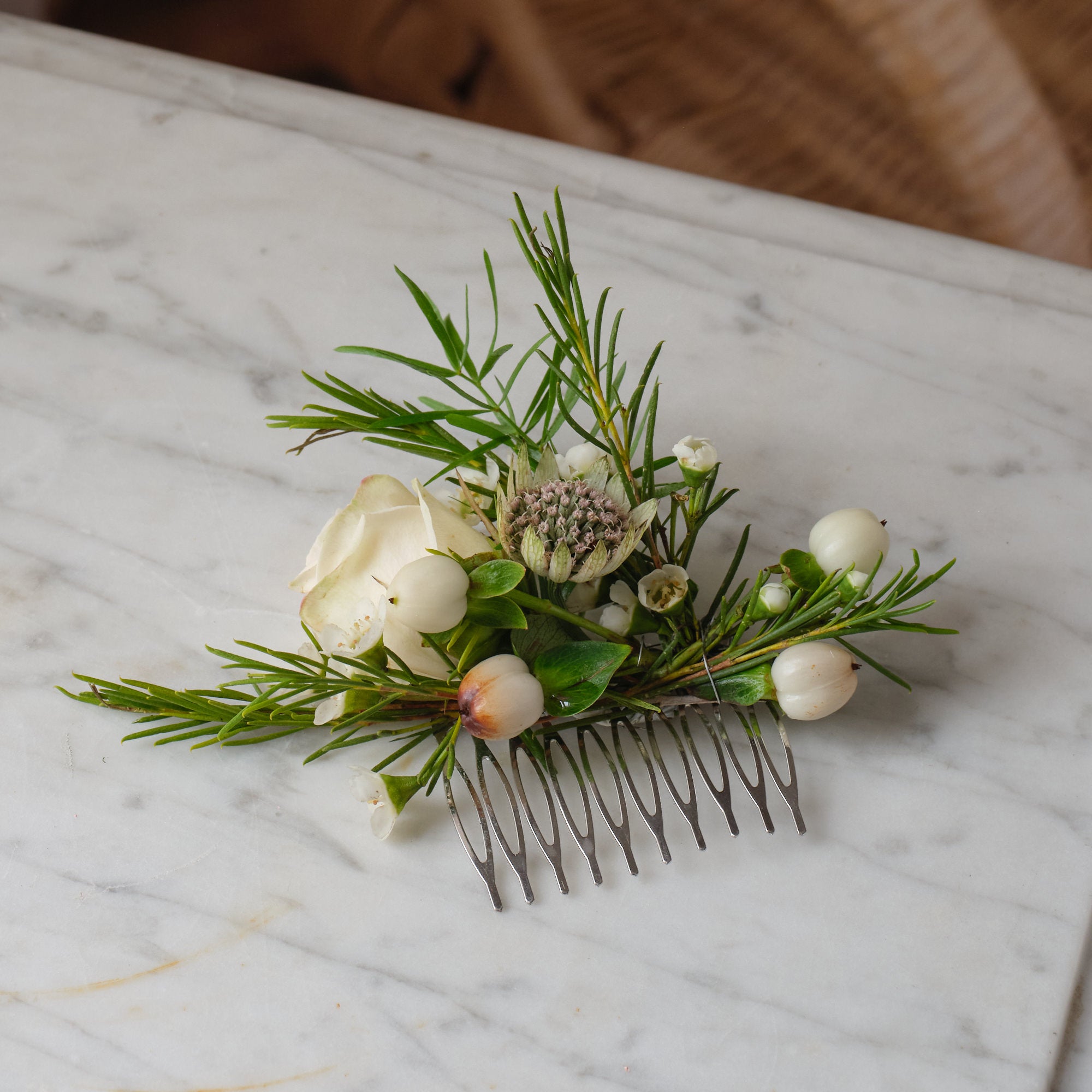 classic white flower hair comb with white and off white seasonal roses and other flowers