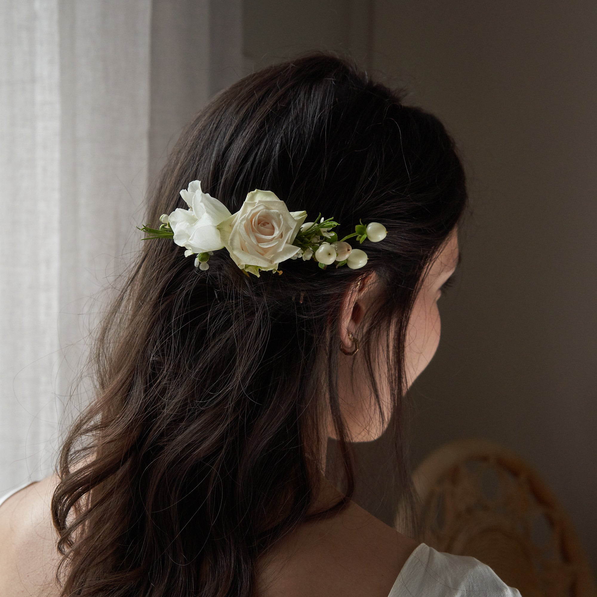 classic white flower hair comb with white and off white seasonal flowers and fresh foliage