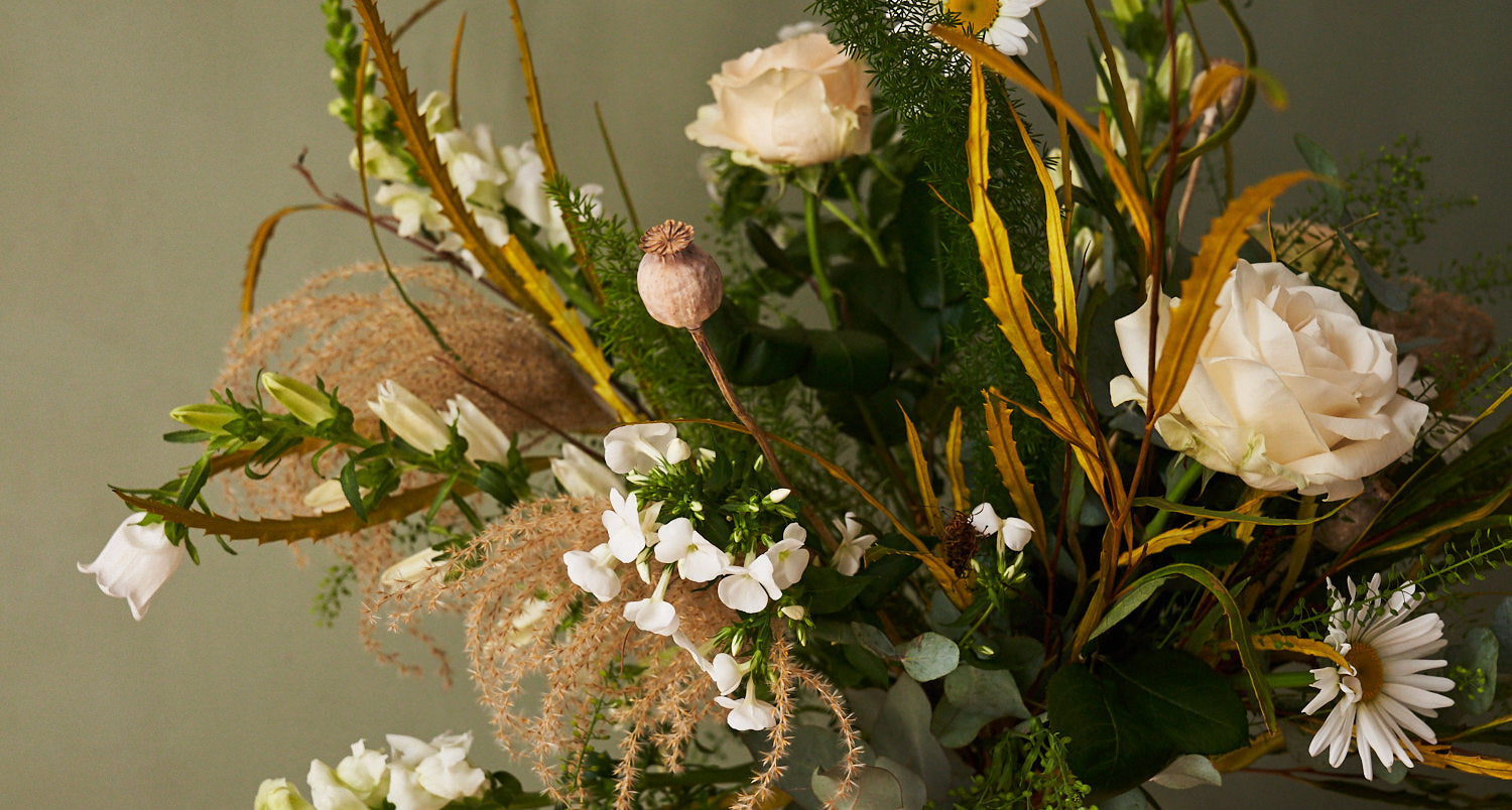 whimsical white bouquet with white roses, eucalyptus, grasses
