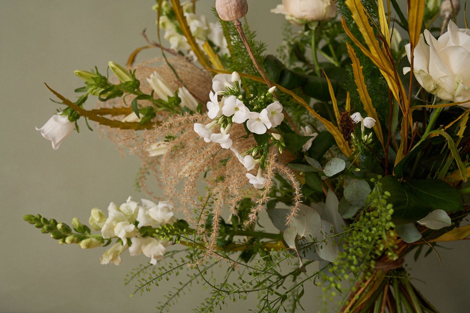 whimsical white bouquet with white roses, eucalyptus, grasses
