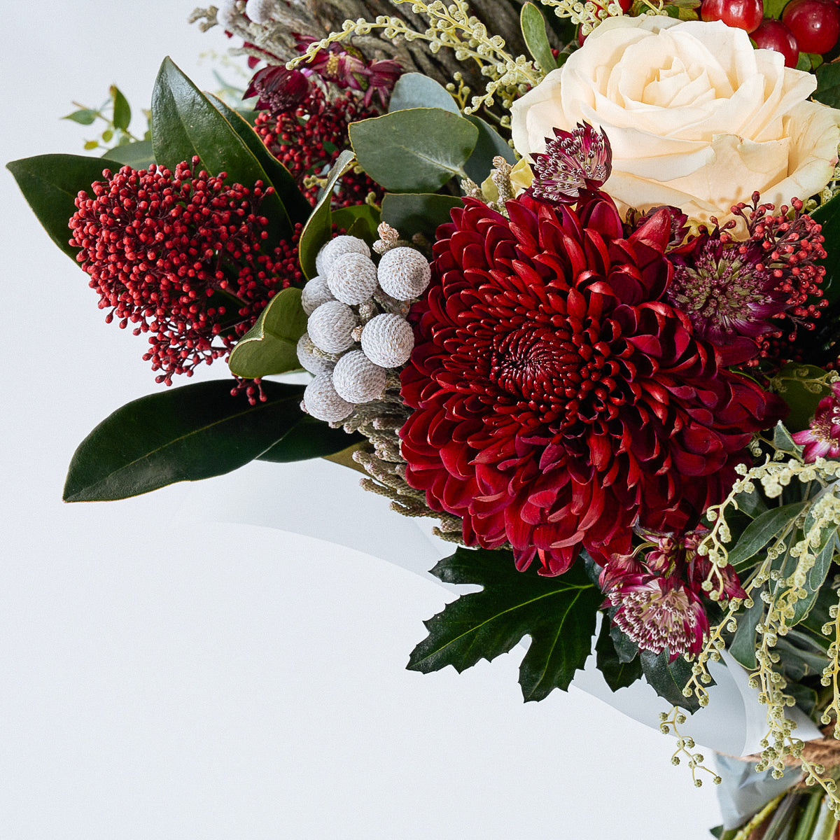 Noel Christmas bouquet with burgundy flowers, white roses and berries