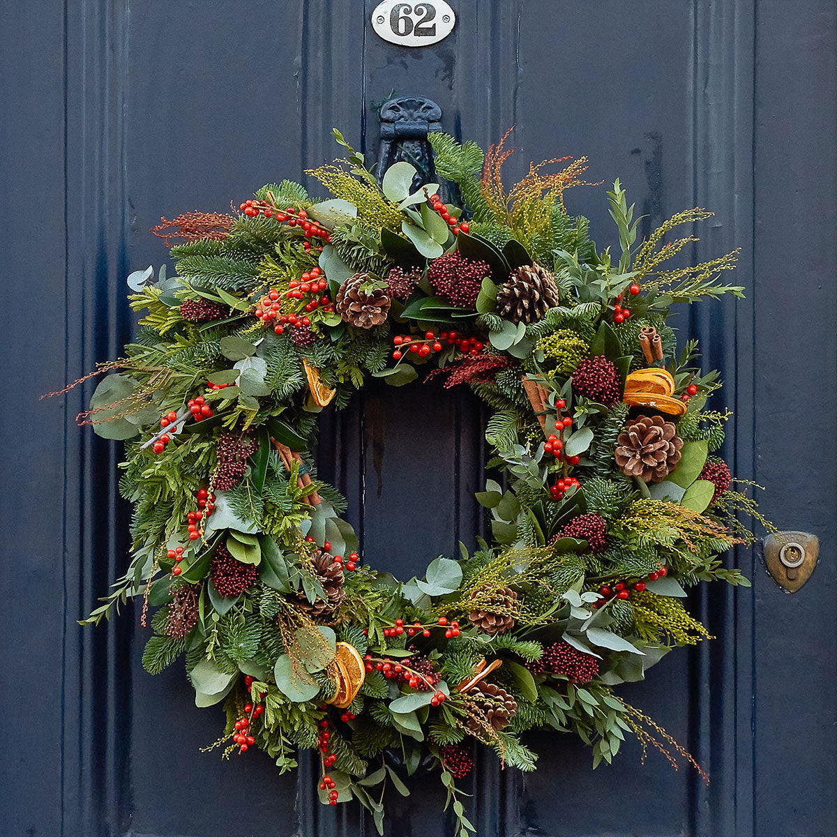 christmas wreath classic design with pine cones, dried oranges and berries by Botanique Workshop London