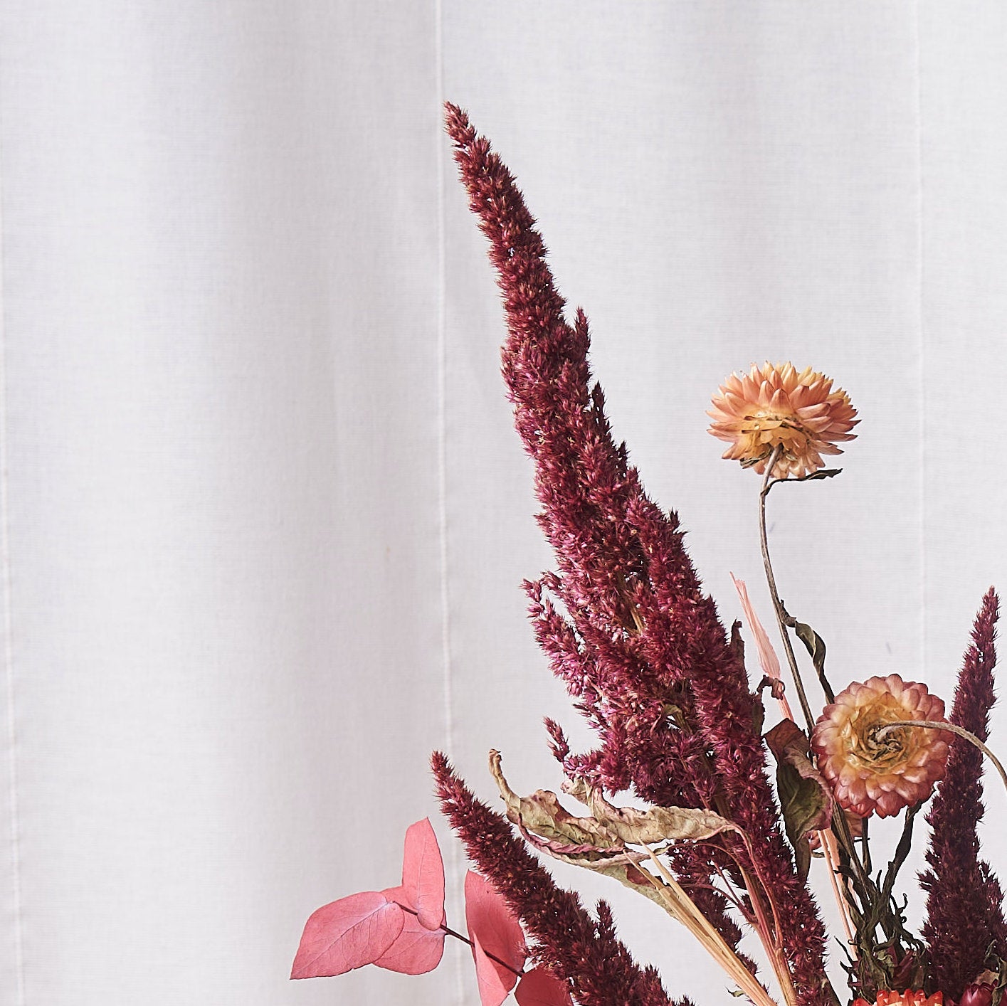 dried flowers bunch with coral straw flowers and amaranthus