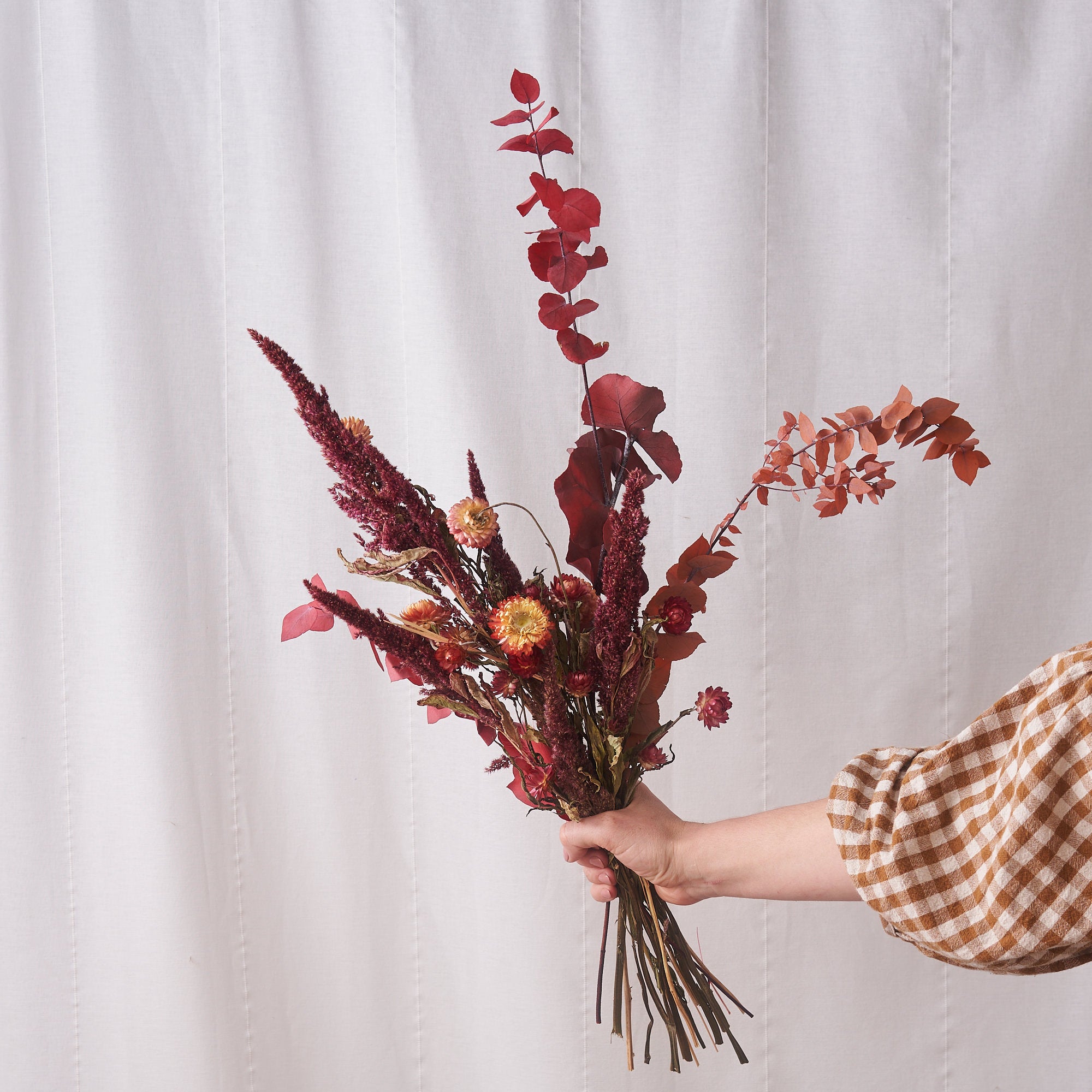 dried flowers bunch with coral straw flowers and amaranthus